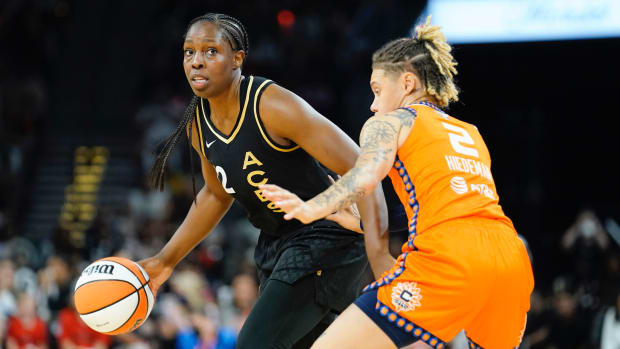 Las Vegas Aces guard Chelsea Gray (12) controls the ball against Connecticut Sun guard Natisha Hiedeman (2) during the second quarter in game one of the 2022 WNBA Finals at Michelob Ultra Arena.